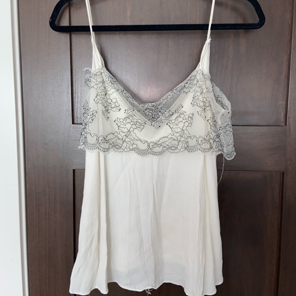 flowy white tank top with floral designed lace